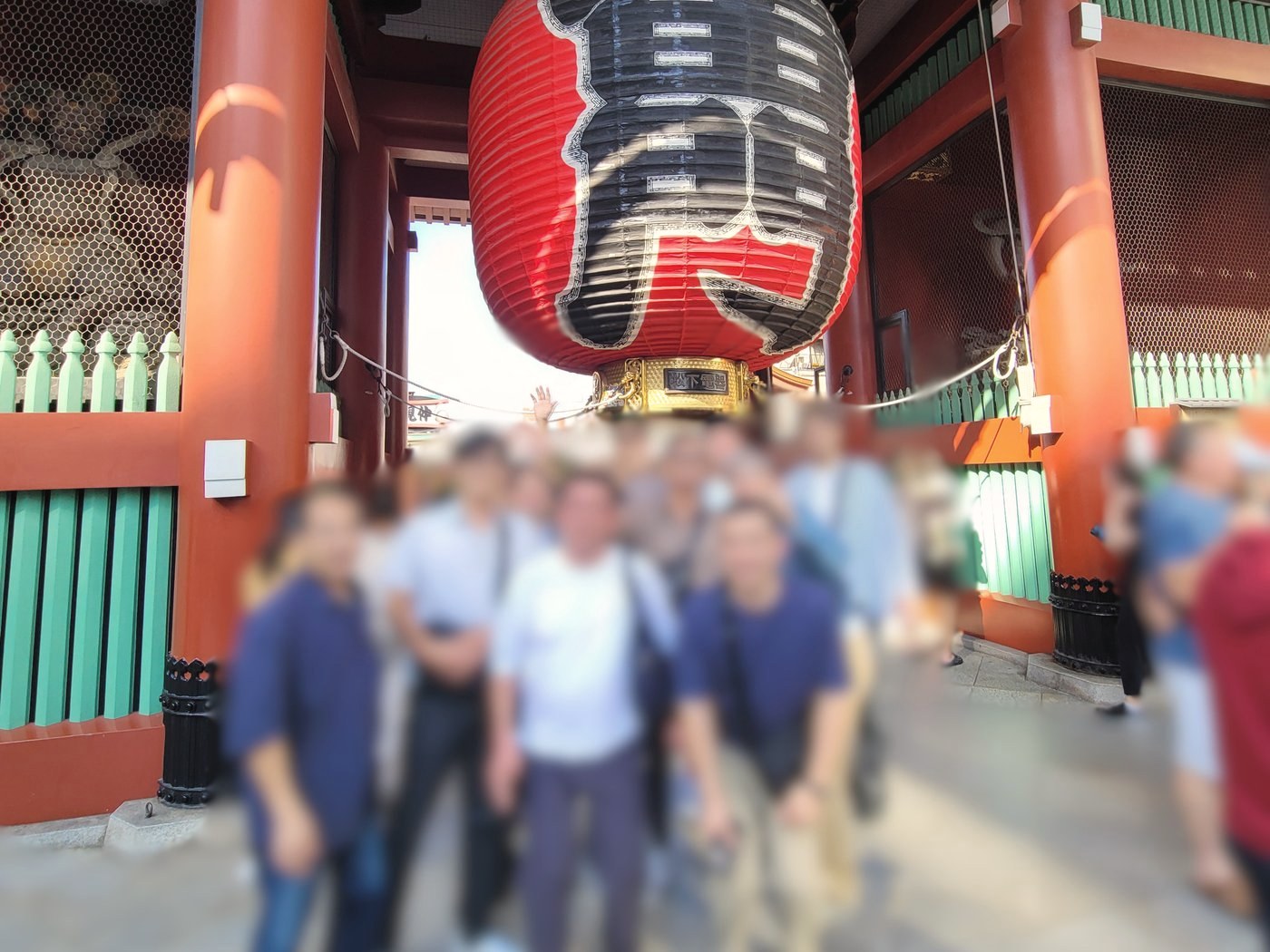 Guests gathered beneath the great red lantern of the Kaminarimon gate at Senso-ji in Asakusa, their faces softly blurred to protect their privacy